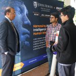 Mohamed Rehman, MD, Chair, Department of Anesthesia, Johns Hopkins All Children's Hospital, converses with 2023-2024 AI2AI Fellows Aniket Roy and Ambar Pal.